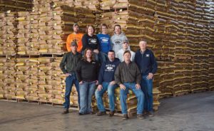 welter seed employees in front of pallets of bagged seed
